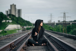 Woman sitting train track hood - liminal space free wallpaper