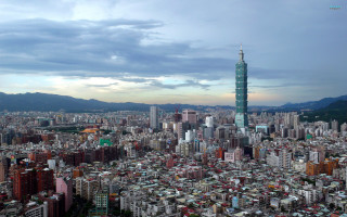 City skyline tall buildings mountains - tilt shift free wallpaper