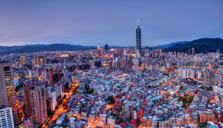 Cityscape tall building nighttime lights - free city wallpaper