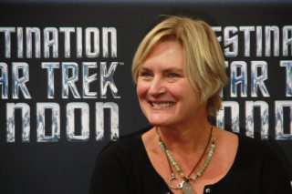 Woman smiling star trek sign - her neck and a necklace free wallpaper