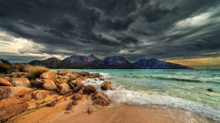 Beach rocky shoreline mountains cloudy - bob thompson free wallpaper
