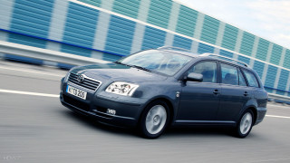 Blue car driving street building - a blue sky in the foreground free wallpaper