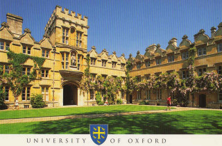 Large building clock tower green - a green lawn in front free wallpaper