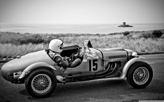 Man driving race car ocean - a race car free wallpaper