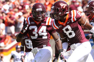 Men maroon white uniforms playing - a crowd in the background free wallpaper