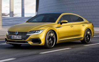 Yellow volkswagen arteus driving street - column free wallpaper
