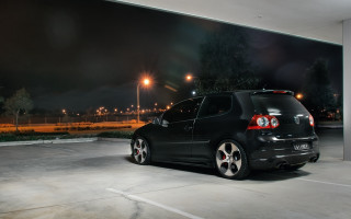 Black car parked night lights - a black car free wallpaper