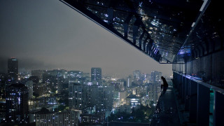 Person standing ledged overlooking city - a ledge free wallpaper