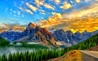 Mountain road forest sunset lake - a scenic view of a mountain range free wallpaper