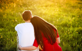 Couple hugging in grass looking - a couple of people free wallpaper for desktop