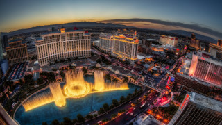 City fountain nighttime lights buildings - a fountain in the middle of it free wallpaper
