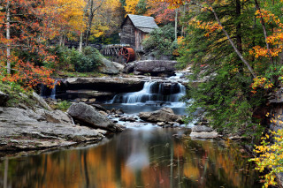 Small waterfall forest wooden building - a small waterfall in a forest free wallpaper