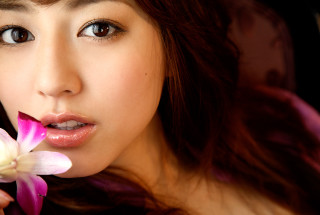 Woman holding flower smiling camera - her mouth free wallpaper