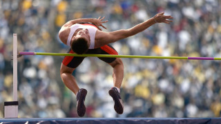 Man jumping high bar competition - the stand free wallpaper