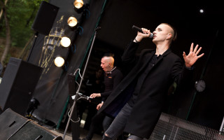 Man standing stage microphone singing - a microphone free wallpaper