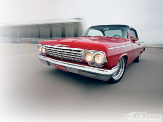 Red car driving street building 5 - a red car free wallpaper