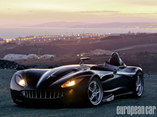 Black sports car hill city - a person in the driver seat free wallpaper