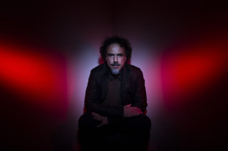 Man sitting dark room red - chafik charobim free wallpaper