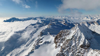 Mountain range plane window clouds 2 - a view of a mountain range free wallpaper