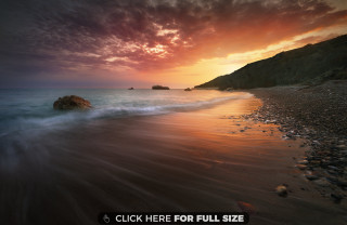 Beach rock sunset red sky - a rock in the middle of it free wallpaper