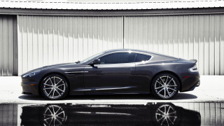 Grey sports car parked building 2 - a wall behind free wallpaper