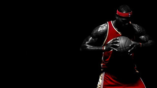 Man holding basketball red uniform 2 - a basketball free wallpaper