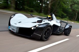 White black car driving forest - a person in the driver seat free wallpaper