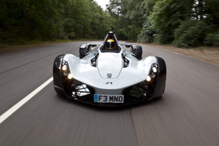 White racecar driving forest road - a white race car free wallpaper