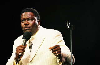 Man suit microphone serious look - cleve gray free wallpaper