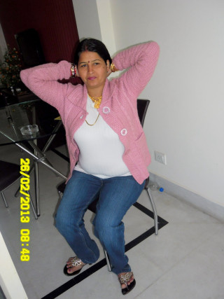 Woman sitting pink jacket denim - her hand behind her head free wallpaper