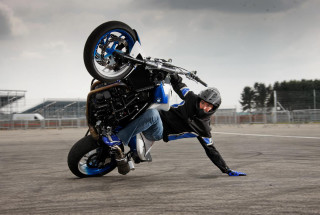 Man wheelie motorcycle parking lot - his head free wallpaper for desktop