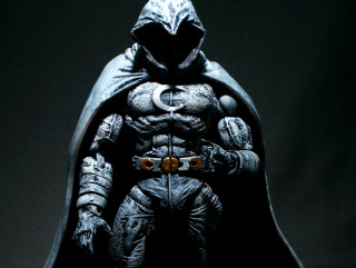 Statue man batman costume hood - a moon in the background free wallpaper