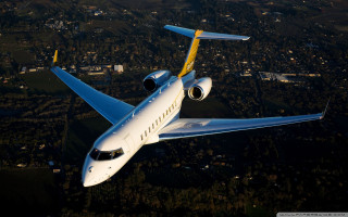 White yellow airplane flying city - tree and hills free wallpaper