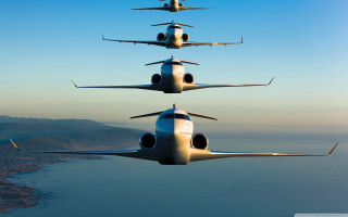 Planes flying water mountains blue - symmetrical balance free wallpaper