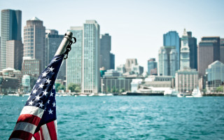 Flag cityscape bridge water ship - a boat in the foreground free wallpaper