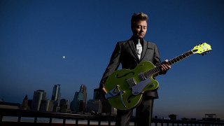 Man suit green guitar city - a city skyline free wallpaper