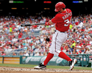 Baseball player swinging bat ball - a baseball player free wallpaper
