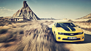 Yellow car dirt road mountains - a yellow car free wallpaper