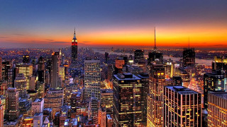 City skyline tall buildings night 15 - orange sky in the background free wallpaper