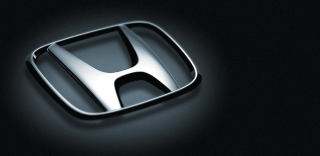 Car emblem closeup black background - letterism free wallpaper