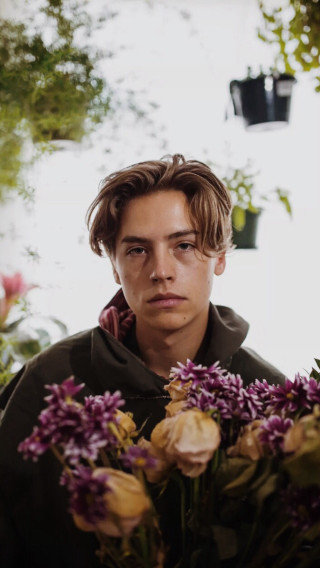 Man holding flowers serious look - grunge aesthetic free wallpaper