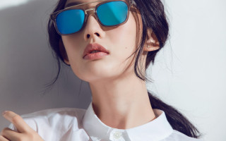 Woman sunglasses white shirt pointing - the side of her face free wallpaper