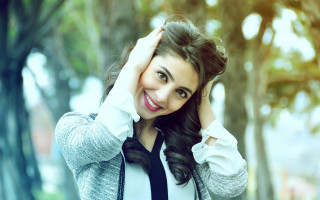 Smiling woman holding hair tree - holding free wallpaper
