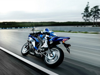 Blue motorcycle driving road trees - a blue motorcycle free wallpaper