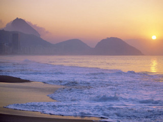 Sunset ocean beach mountains person - a sunset over the ocean free wallpaper