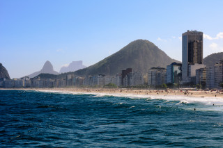 Beach mountain buildings shore foreground - international typographic style free wallpaper for desktop