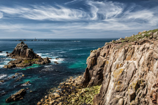 Rocky cliff water boat distant - a rocky cliff free wallpaper