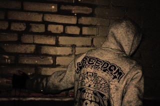 Hoodie person brick wall fire - a brick wall free wallpaper