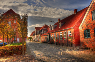 Cobblestone street redbricks cloudy sky - a blue car free wallpaper