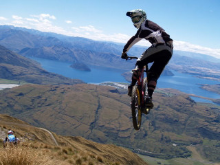 Man riding bike mountain lake - dave allsop free wallpaper